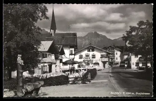 AK Seefeld i. T., Dorfstrasse mit Brunnen, Café und Kirche