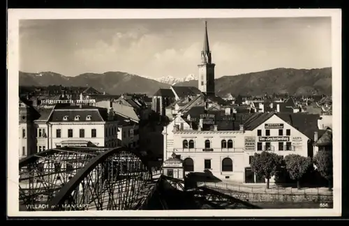 AK Villach, Brücke und Stadt mit Kirchturm, Mangart im Hintergrund