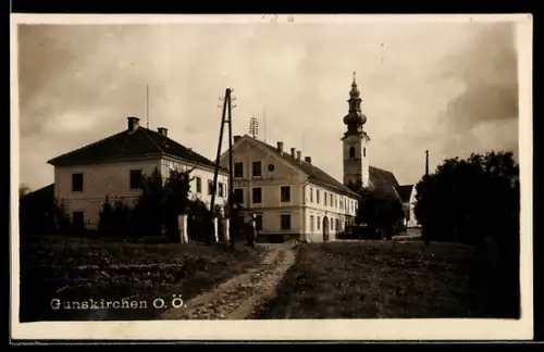 AK Gunskirchen /O. Ö., Ortspartie mit Feldweg u. Kirche