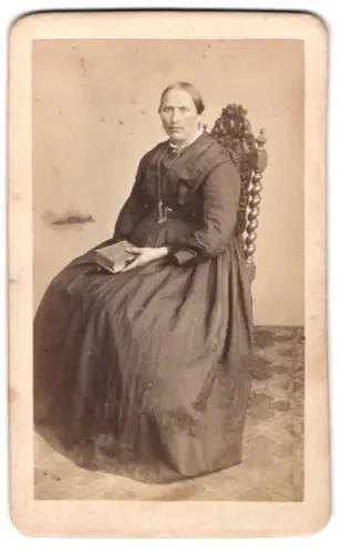 Fotografie Ferd. Bak, Sigmaringen, Würdevoll sitzende Dame mit Buch