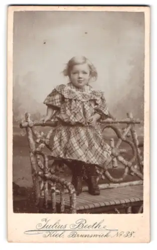 Fotografie Julius Beeth, Kiel, Brunswick 38, Kind auf rustikalem Stuhl, 1905