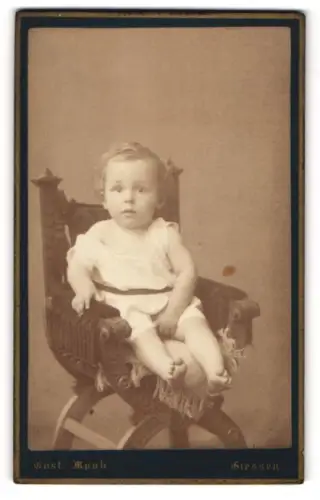 Fotografie Gustav Mook, Giessen, Portrait niedliches Kleinkind im weissen Hemd auf Stuhl sitzend