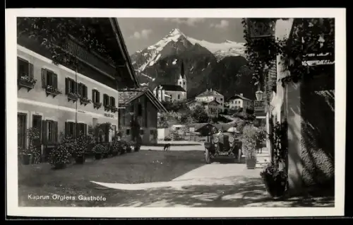 AK Kaprun, Öfglers Gasthöfe mit Strasse, Kirche und Bergpanorama