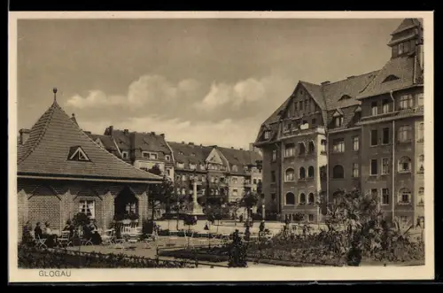 AK Glogau, Ortspartie, Platz, Parkanlage und Häuserzeile