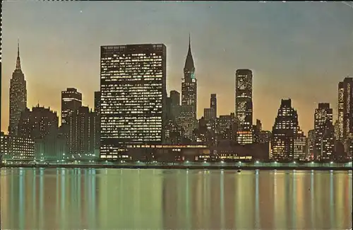 New York City Panoramic view of Skyline at night Empire State Building United Nations Chrysler and Pan Am Building / New York /