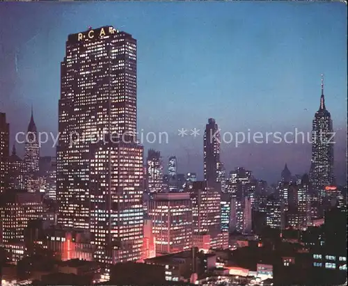 New York City Night falls on Midtown Manhattan RCA Building Chrysler Building Empire State Building / New York /