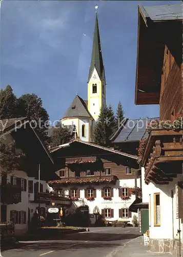 Kirchberg Tirol Hauptstrasse mit Unterrainwirt Gaststaette Kirche Kat. Kirchberg in Tirol