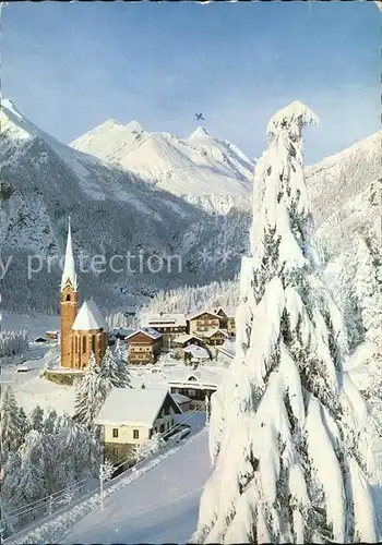 AK / Ansichtskarte Heiligenblut Kaernten Teilansicht mit Kirche und Grossklockber im Winterkleid Kat. Heiligenblut