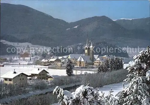 AK / Ansichtskarte St Lorenzen Suedtirol Ortsansicht mit Kirche Winterlandschaft