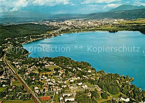 AK / Ansichtskarte Krumpendorf Woerthersee Alpenseebad mit Blick auf Klagenfurt Fliegeraufnahme