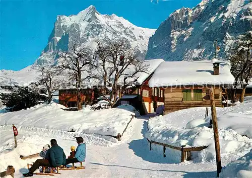 AK / Ansichtskarte Grindelwald Winterpanorama mit Wetterhorn Schlittenfahren Kat. Grindelwald