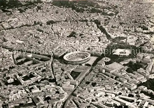 AK / Ansichtskarte Nimes Les Arenes et l Esplanade vue aerienne Kat. Nimes