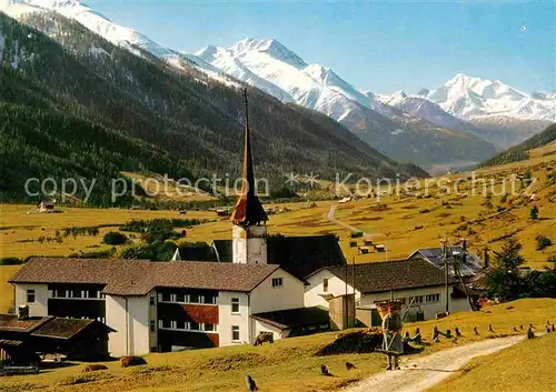 AK / Ansichtskarte Muenster Goms Ortsansicht mit Kirche Blick zum Weisshorn Walliser Alpen