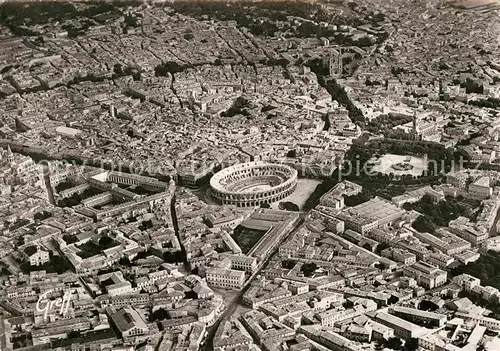 AK / Ansichtskarte Nimes Les Arenes et l Esplanade vue aerienne Kat. Nimes