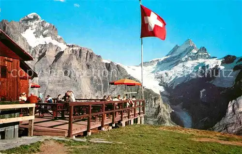 AK / Ansichtskarte Grindelwald Bergrestaurant First mit Wetterhorn und Schreckhorn Berner Alpen Schweizer Flagge Kat. Grindelwald