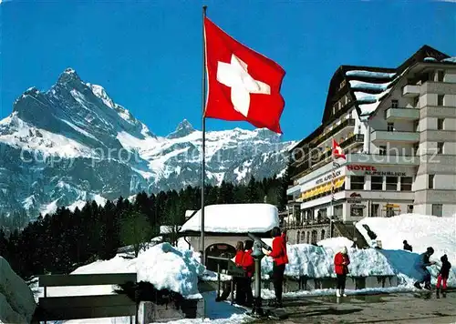 AK / Ansichtskarte Braunwald GL Hotel Alpenblick Bahnhofterrasse Blick gegen Ortstock und Hoher Turm Alpen Schweizer Flagge Kat. Braunwald