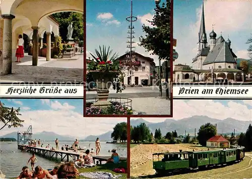 AK / Ansichtskarte Prien Chiemsee Marktbrunnen Maibaum Ortskirche Schwimmbad Chiemseebahn Kampenwand Alpen Kat. Prien a.Chiemsee