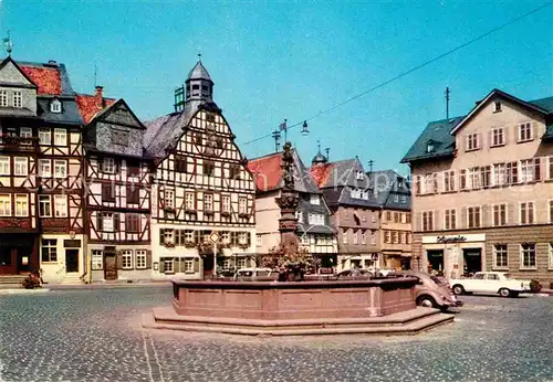 AK / Ansichtskarte Butzbach Marktbrunnen Rathaus Fachwerkhaeuser Kat. Butzbach