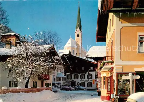 AK / Ansichtskarte Kirchberg Tirol Ortsmotiv mit Kirche im Winter Kat. Kirchberg in Tirol