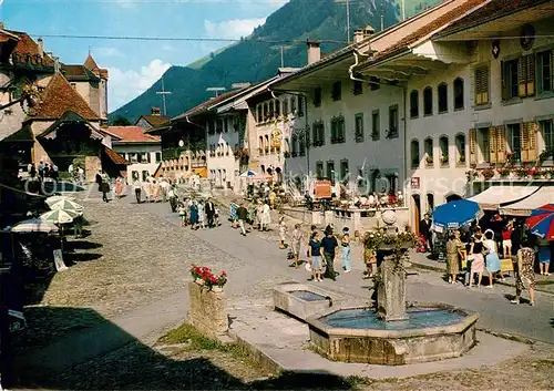 AK / Ansichtskarte Gruyeres FR Ortsmotiv mit Brunnen Kat. Gruyeres