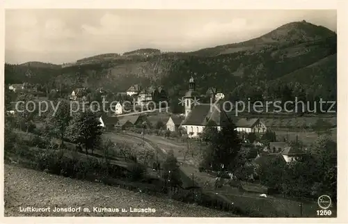 AK / Ansichtskarte Jonsdorf Ortsansicht mit Kirche und Kurhaus Blick zur Lausche Zittauer Gebirge Kat. Kurort Jonsdorf