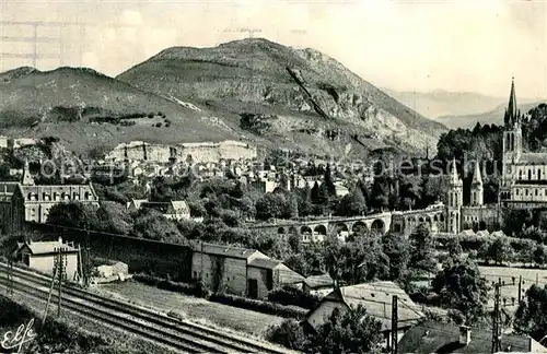 AK / Ansichtskarte Lourdes Hautes Pyrenees Vue generale prise de la Route de Pau Chemin de Fer Eglise Pont Kat. Lourdes