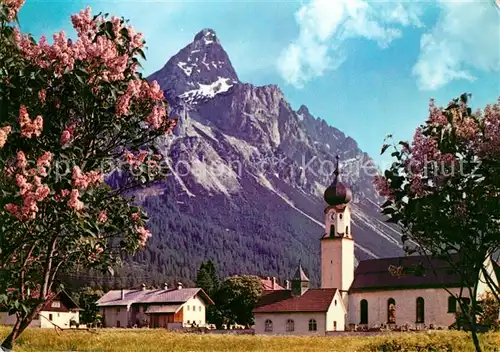 AK / Ansichtskarte Ehrwald Tirol Ortsansicht mit Kirche Baumbluete Sonnenspitze Mieminger Kette