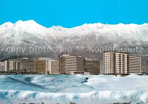 AK / Ansichtskarte Innsbruck Olympisches Dorf gegen Nordkette Winterpanorama Kat. Innsbruck