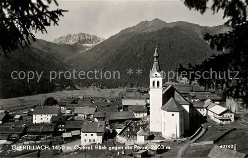 AK / Ansichtskarte Obertilliach Ortsansicht mit Kirche Blick gegen die Porze Karnische Alpen Obertilliach