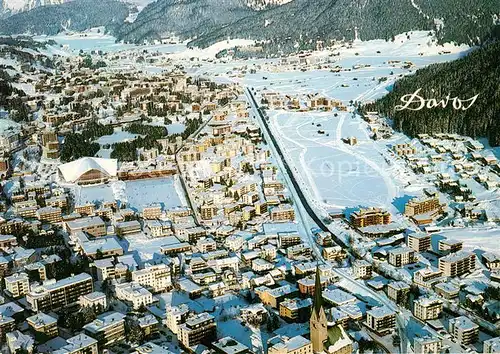 AK / Ansichtskarte Davos_GR Eissporthalle Natureisbahn Langlaufzentrum Wintersportzentrum Alpen Fliegeraufnahme Davos_GR