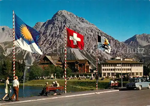 AK / Ansichtskarte Arosa_GR Bahnhofquartier mit Schiesshorn Fahnen Arosa_GR