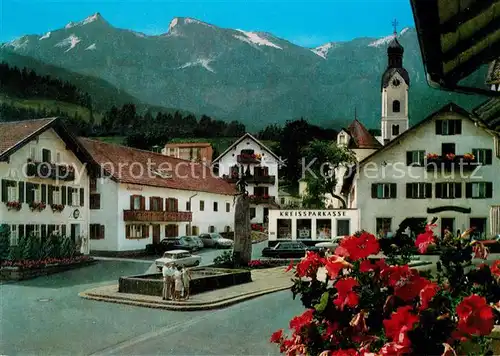 AK / Ansichtskarte Bad_Kohlgrub Ortszentrum Brunnen Kirche Alpenblick Bad_Kohlgrub