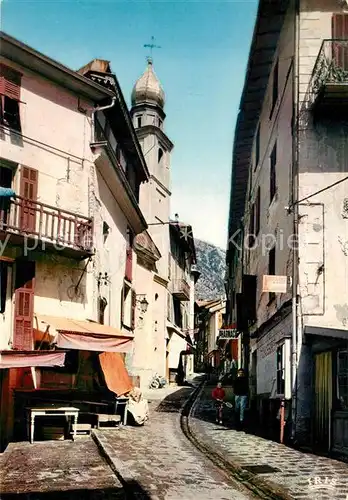 AK / Ansichtskarte Saint Martin Vesubie Chapelle des Penitents Blancs Ruisseau sur rue centrale Saint Martin Vesubie