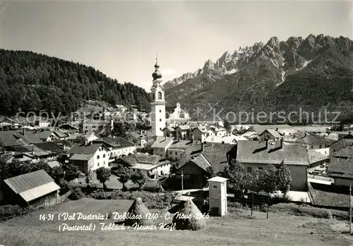 AK / Ansichtskarte Toblach_Suedtirol mit Kirche und Neunerkofl Toblach_Suedtirol