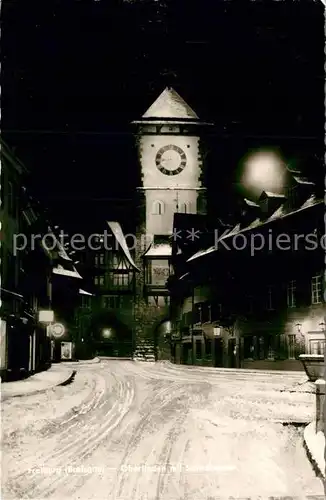 AK / Ansichtskarte Freiburg_Breisgau Stadttor Nachtaufnahme Freiburg Breisgau