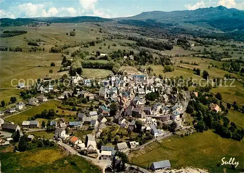 AK / Ansichtskarte La_Tour d_Auvergne Dans le fond la chaine du Sancy Vue aerienne La_Tour d_Auvergne