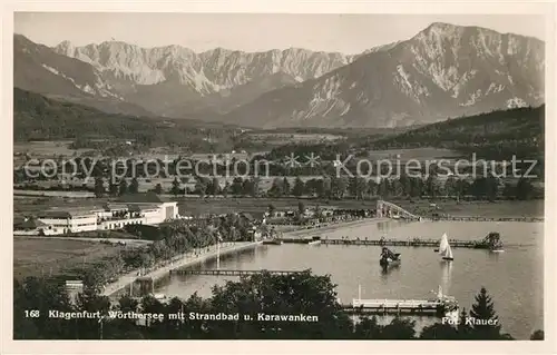 AK / Ansichtskarte Klagenfurt_Woerthersee Panorama mit Strandbad und Karawanken Klagenfurt_Woerthersee