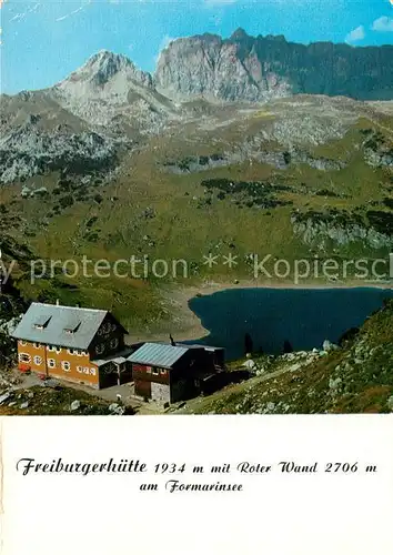 AK / Ansichtskarte Freiburgerhuette Berghaus mit Roter Wand am Formarinsee Lechquellengebirge Freiburgerhuette