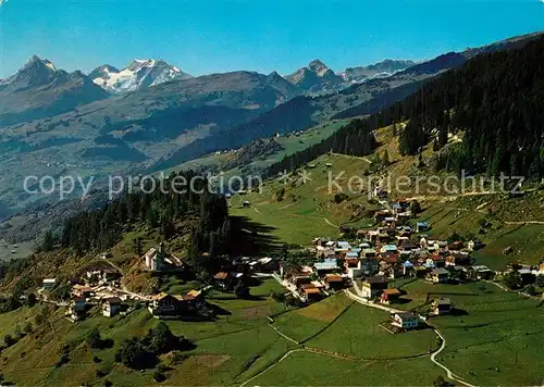 AK / Ansichtskarte Ruschein_GR mit Brigelserhoernern Buendner Oberland Fliegeaufnahme Ruschein GR