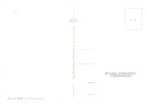 AK / Ansichtskarte Reit_Winkl Ortsansicht mit Kirche Blick zum Kaisergebirge Reit_Winkl