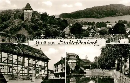 AK / Ansichtskarte Stadtoldendorf Ortsansicht mit Turm Fachwerkhaus Partie am Wasser Stadtoldendorf