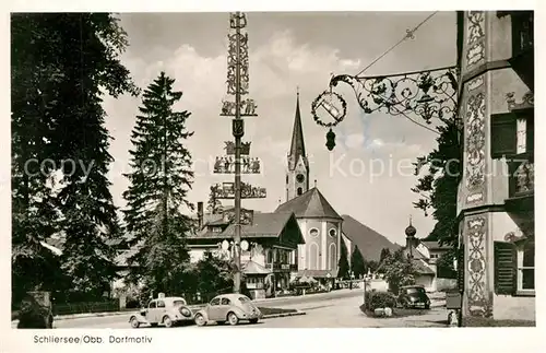 AK / Ansichtskarte Schliersee Dorfmotiv mit Maibaum Blick zur Kirche Schliersee