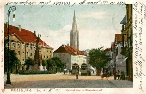 AK / Ansichtskarte Freiburg_Breisgau Kaiserstrasse mit Siegesdenkmal Blick zum Muenster Freiburg Breisgau