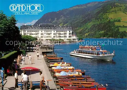 AK / Ansichtskarte Zell_See Seepromenade mit Grand Hotel und Schiffsanlegeplaetzen Zell_See