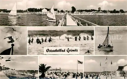 AK / Ansichtskarte Groemitz_Ostseebad Strandpartien Seebruecke Badespass Segelboot Groemitz_Ostseebad