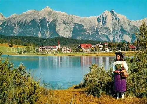 AK / Ansichtskarte Seefeld_Tirol Uferpartie am See Trachten Blick gegen Wettersteingebirge Seefeld Tirol