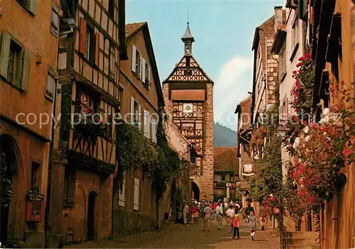 AK / Ansichtskarte Riquewihr_Haut_Rhin Grande Rue fleurie au fond le Dolder XIIIe siecle Riquewihr_Haut_Rhin