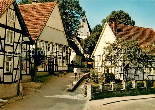 AK / Ansichtskarte Alt_Meinberg Alte Fachwerkhaeuser mit Blick auf evangelische Kirche 