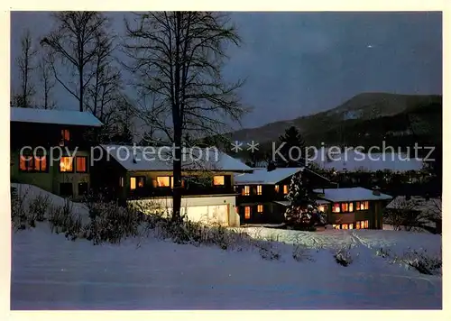 AK / Ansichtskarte Ruhpolding Sporthotel Gaestehaus Am Westernberg im Winter Nachtaufnahme Ruhpolding