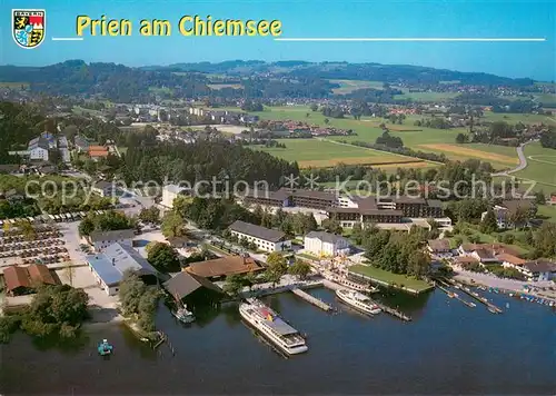AK / Ansichtskarte Prien_Chiemsee Schiffsanlegestelle Herrenchiemsee Schloss Ludwig II und Fraueninsel Benediktiner Kloster Fliegeraufnahme Prien Chiemsee